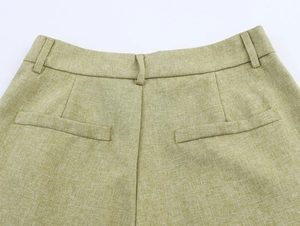 Detailed back waist view of linen texture trousers with belt loops and welt pockets