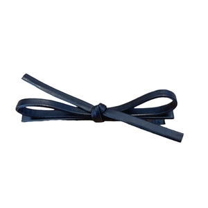 Minimalist black faux leather bow hair clip with metal duckbill clasp on white background