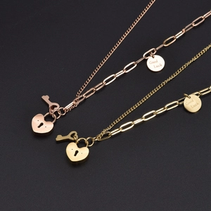 Asymmetric 18k gold heart lock necklace with pearl chain and Good Luck engraved tags