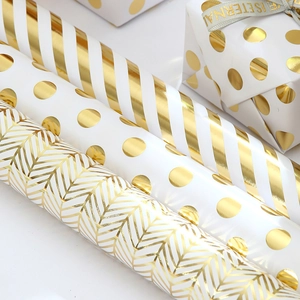 Metallic gold striped and polka dot gift wrapping paper set with ribbons for holiday