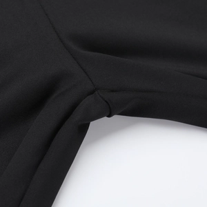 Close-up of high-quality stitching on black one-shoulder jumpsuit elastic fabric