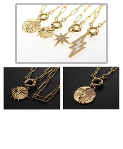 Detail of 18K gold plated celestial pendants featuring sun, moon, and star on paperclip chains