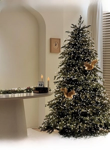 Warm white LED string lights densely wrapped on a green Christmas tree with squirrel decor