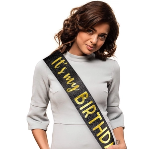 Detail of glitter black 'It's my BIRTHDAY' party sash worn by female model