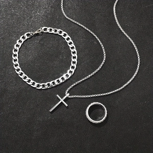 Three-piece silver hip hop jewelry set with cross necklace, cuban bracelet, and textured ring