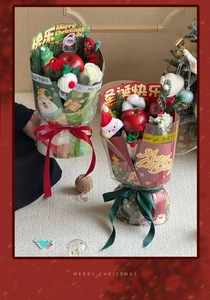 Detailed view of Christmas bouquet with red apples, white roses, and festive plush decor