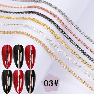 Detail of silver, rose gold, black, and gold metal nail art chains for creative manicure
