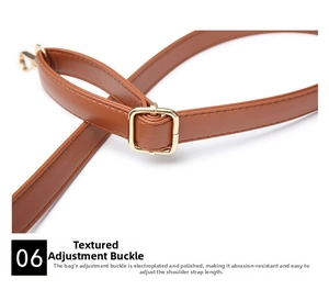 Macro shot of polished gold metal adjustment buckle on brown leather handbag strap
