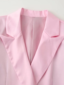Detail shot of pink satin blazer showing the lapel collar and shoulder stitching craftsmanship