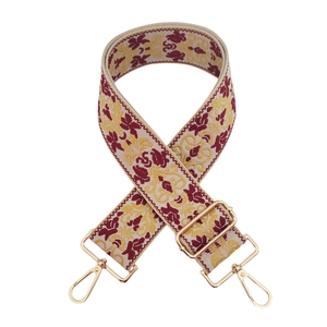 Dettaglio della tracolla jacquard etnica con ricamo bordeaux e fibbie in metallo dorato