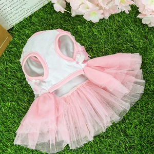 Detail of pink pet dress with multi-layer mesh skirt and white floral ornaments