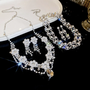 Detailed view of silver floral jewelry set with diamonds and teardrop pearls