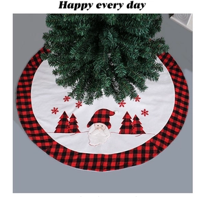 Detail of red and black buffalo plaid Christmas tree skirt with Santa Claus applique