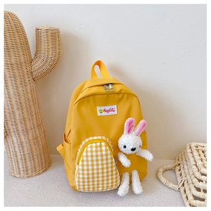 Detail view of yellow canvas toddler backpack with plush bunny and checkered pocket