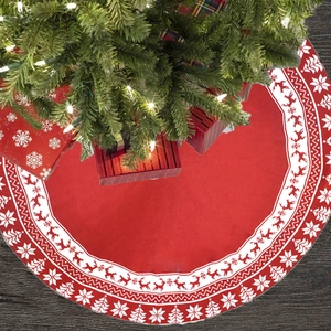 Detail of red and white knitted Christmas tree skirt with reindeer and snowflake patterns
