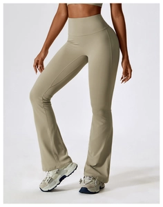 Detail showing high-waisted wide waistband on flared yoga pants in sage green fabric