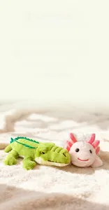 Detail of plush stuffed crocodile and pink axolotl toys on a soft warm white carpet