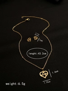 Macro shot of gold heartbeat jewelry set with dimensions and weight on leather background