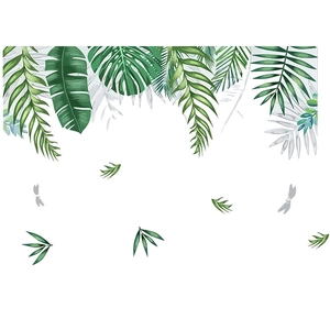 Detail view of tropical green leaf wall stickers featuring monstera and dragonfly elements