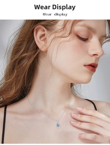 Close-up of S925 silver moissanite pendant necklace on model with refined claw setting