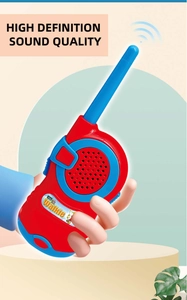 Close-up of child holding a red and blue toy walkie talkie with cartoon style design