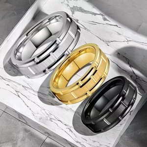 Grooved stainless steel rings for men in silver, gold, and black with a brushed finish