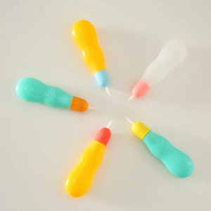 Close-up of five colorful plastic painting tools for children DIY watercolor art activities