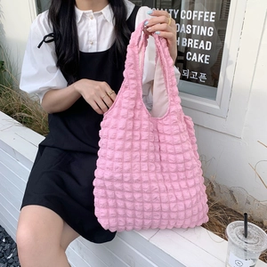 Detailed view of the pink 3D bubble texture and stitching on the stylish tote bag