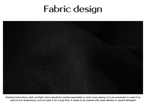 Close-up of black wool fabric texture with detailed washing instructions text