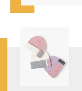 Detailed knit texture of multi-colored ribbed beanies in soft cashmere-like yarn material