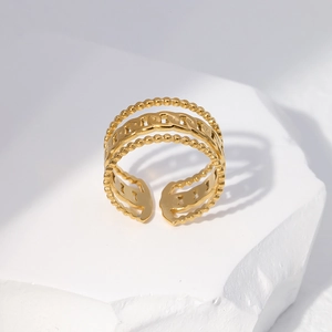 Detailed view of golden triple-layered chain link ring with adjustable open band design