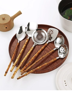 Set of 6 stainless steel kitchen utensils with natural bamboo handles on a round tray