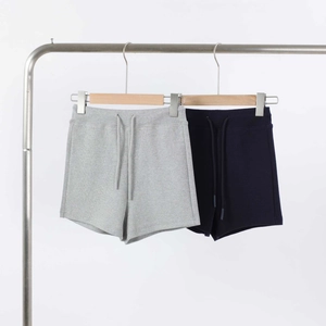 Detail of light grey and navy blue high waist gym shorts with adjustable drawstrings