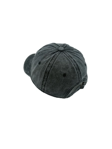 Detail view of washed cotton baseball cap with adjustable metal buckle and twill texture