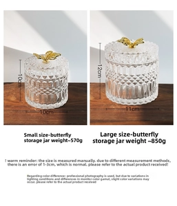Detail of embossed glass storage jars with golden butterfly lids in two sizes
