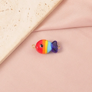 Macro detail of hand-painted rainbow glass clownfish pendant with golden loops