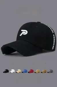 Detail of distressed baseball cap featuring letter P embroidery and fringe edge brim