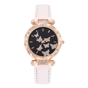 Close-up of pink leather watch featuring a black dial with sparkling crystal butterflies