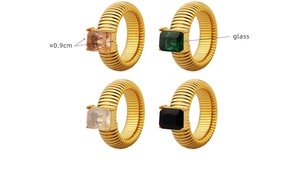 Detail of colorful glass gems on gold-tone spiral titanium steel rings with 0.9cm stones