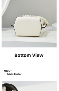 Detail view of the mini phone bag's bottom with gold rivets and woven leather side texture