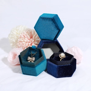 Elegant hexagonal velvet jewelry boxes in peacock blue and navy for rings and necklaces