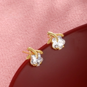 Macro shot of star-shaped zircon earrings with 24k gold plating and sparkling stones