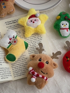Flat lay of Christmas plush ornaments with embroidery on a warm retro background