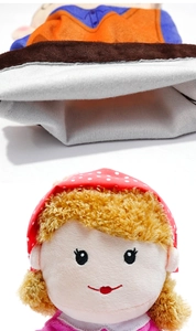 Detail of plush puppet showing soft fabric interior and fine facial embroidery
