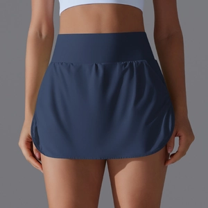 Detail of high-waist navy blue tennis skirt featuring wide waistband and smooth matte fabric