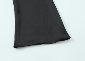 Detail of black satin fabric sleeve cuff with professional stitching and hem finish