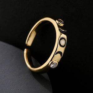 Gold open ring with colorful enamel celestial moon and eye motifs set with zircons