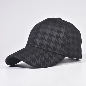 Detail shot of black houndstooth pattern on structured baseball cap with 45-degree side view