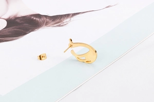 Detail of gold stainless steel crystal stud earrings with matching butterfly backings