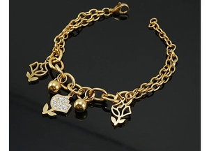 Close-up of gold stainless steel multi-layer chain bracelet with rose and ball charms